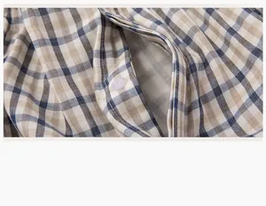 Detail of the placket and white button on a checkered cotton double gauze pajama set