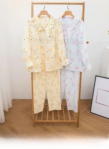 Detail of floral cotton pajamas set with button-down tops and ruffle collar design