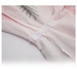 Detail of reinforced crotch stitching on pink flamingo cotton baby bodysuit