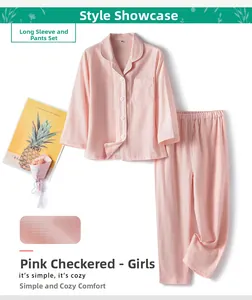 Detail of pink plaid cotton pajamas for girls featuring white buttons and a chest pocket