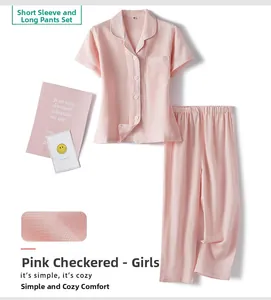 Detail of pink checkered girls cotton pajama set with short sleeve top and long pants