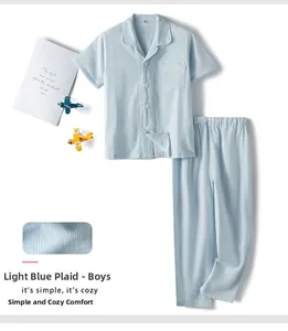 Flat lay of light blue gingham cotton pajamas for boys with shirt and pants