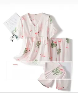 Detail of pink cotton pajama set with flamingo print, V-neck and ruffle texture