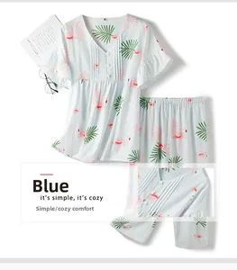 Close-up of pink flamingo pattern and button detail on blue cotton pajama set