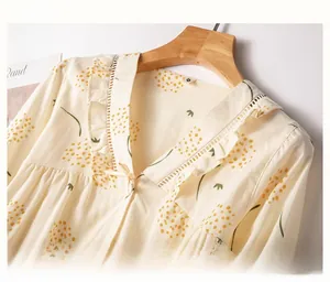 Detail of V-neckline with delicate ruffle trim and yellow floral print on cotton fabric