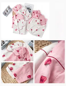 Detail of strawberry print cotton pajamas with contrast piping and textured fabric
