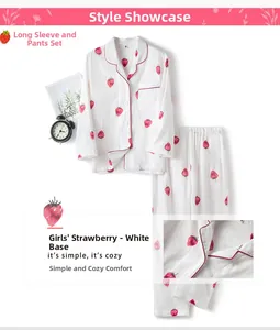 Detail of girls' cotton pajama set featuring red strawberry prints and button-down collar