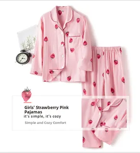 Detail view of girls pink cotton strawberry pajamas with button-down shirt and long pants