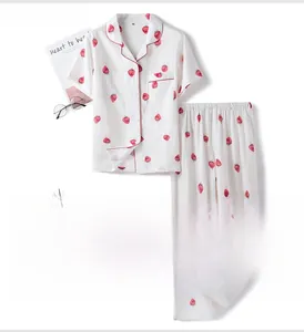 Detail of white cotton strawberry pajamas showing the collar with red piping trim