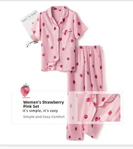 Detail of pink cotton pajamas featuring red strawberry print and fine stitching textures