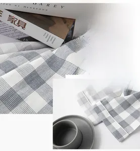 Close-up of blue and white checkered cotton fabric texture with minimalist home decor