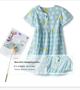 Detail of blue cotton girl's dress with hedgehog print and round neck with wood button