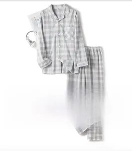 Flat lay of men's cotton plaid pajamas set with shirt and pants in grey large check