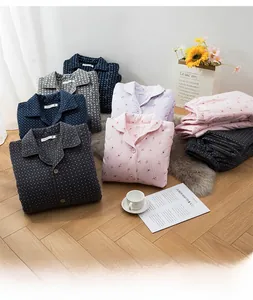Detailed view of quilted cotton thermal pajamas in various patterns on a wooden floor