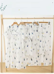 Detail of soft cotton sleepwear with green potted plant print and ruffled blue trims