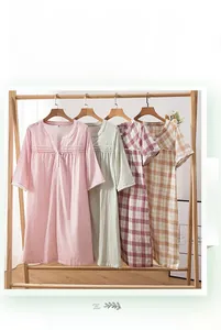 Detail of short sleeve cotton sleepwear featuring lace cuffs and V-neck button design