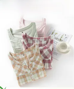 Detail of soft cotton gauze sleepwear necklines featuring delicate lace and button accents