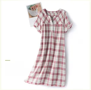 Detail of pink plaid cotton nightgown with white lace trim and V-neckline buttons