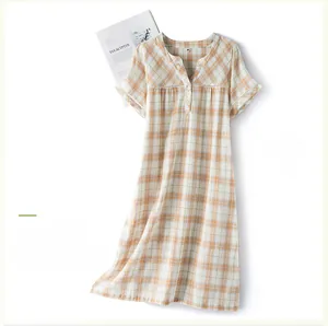 Detailed view of the V-neck lace trim and plaid pattern on the cotton nightgown