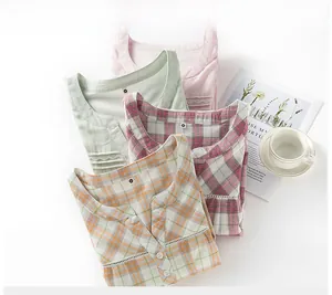 Detail of pure cotton gauze nightdress showing lace collar and soft plaid patterns