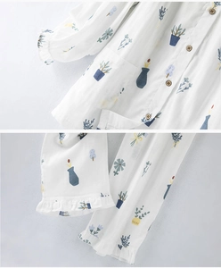 Detail of cotton pajama set featuring green potted plant prints and ruffled sleeve cuffs