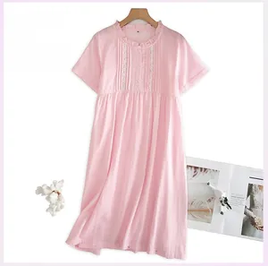 Close-up of pink checkered cotton nightdress with delicate ruffle collar and lace details