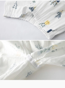 Detail of baby cotton gauze pants with elastic waistband and floral print pattern