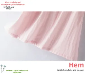 Detail of pink plaid cotton nightdress featuring delicate lace hem and breathable texture
