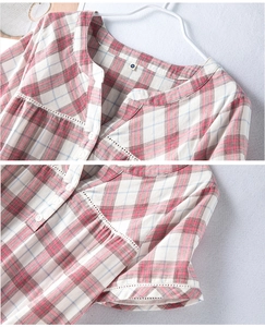 Detail of pink plaid cotton nightdress with delicate lace edges and V-neckline
