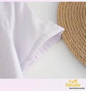 Detail of lavender gingham cotton nightdress showing neat stitching on the cuff design