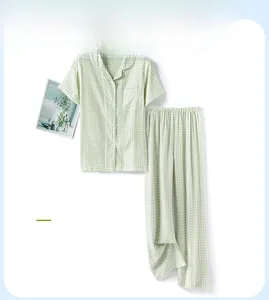 Detail of light green plaid cotton pajamas with button-up top and long trousers