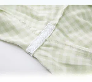 Detailed macro view showing the reinforced crotch seam with white cotton tape on plaid pajamas