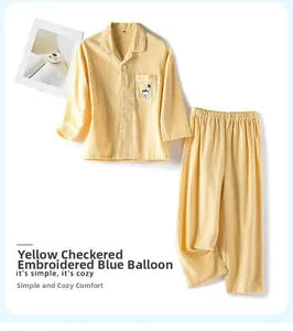 Details von gelbem Karo-Kinderpyjama aus Baumwolle mit blauer Ballon-Stickerei am Beutel