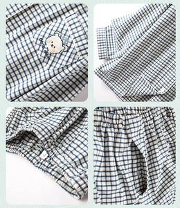 Detailed views of cotton pajama embroidery, plaid texture, and waistband stitching