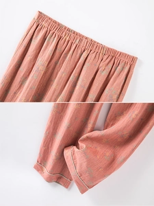 Detail view of cotton floral pajama pants with elastic waist and green piping trim