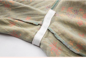 Close-up of the jacquard cotton fabric with red floral pattern and elastic band stitching