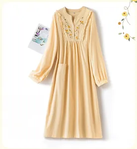 Detail of apricot yellow cotton sleep dress with floral embroidery and lace ruffles