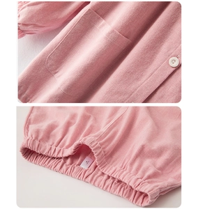 Detail of pink waffle fabric kids loungewear featuring soft pocket, button and elastic cuff
