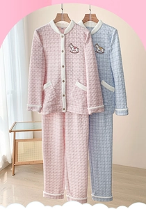 Detail of quilted thermal pajamas featuring cute horse embroidery and plush white trims