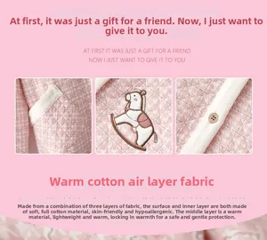 Detail of pink quilted three-layer cotton pajama with embroidery and wooden buttons