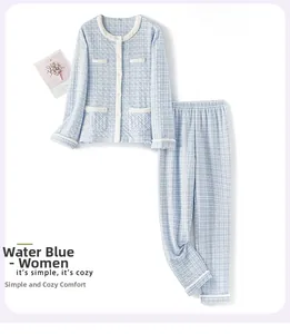 Flat lay of women's quilted tweed lounge set in light blue featuring white piping detail