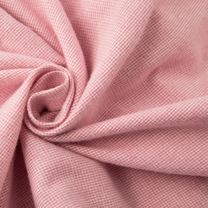 Pink and white woven cotton fabric texture with spiral fold pattern for soft sleepwear