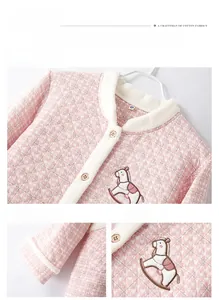 Detail of pink quilted loungewear with pony embroidery and wooden buttons