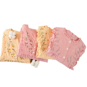 Infant cotton vest with floral embroidery and ruffle trim in pink and yellow colors