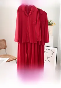 Detail of red mercerized cotton pajama set with lapel buttons and chest pocket embroidery