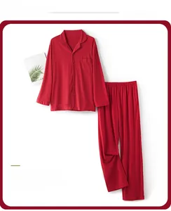Detailed flat lay of red cotton long-sleeved pajamas set with buttons and chest pocket