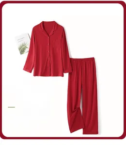 Detail view of men's deep red cotton sleepwear set with button-down shirt and trousers