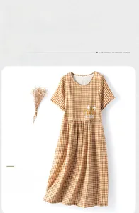 Detail of caramel gingham cotton nightdress with delicate floral embroidery and pleats