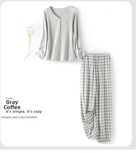 Detail of greige V-neck ribbed knit top with bird embroidery and checkered pajama pants