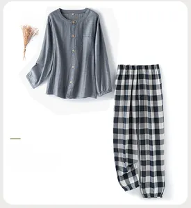 Detail of navy blue cotton loungewear set featuring wooden buttons and plaid pajama pants
